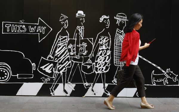 A woman walks in front of an advertisement for a clothing store in Tokyo, Japan, 10 September 2010. (Reuters/Yuriko Nakao)