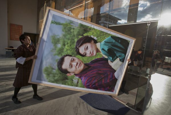 Men carry a portrait of King Jigme Khesar Namgyel Wangchuck and his wife Jetsun Pema to display inside a modern office building in Bhutan's capital Thimphu. (Photo: Reuters/Adrees Latif).