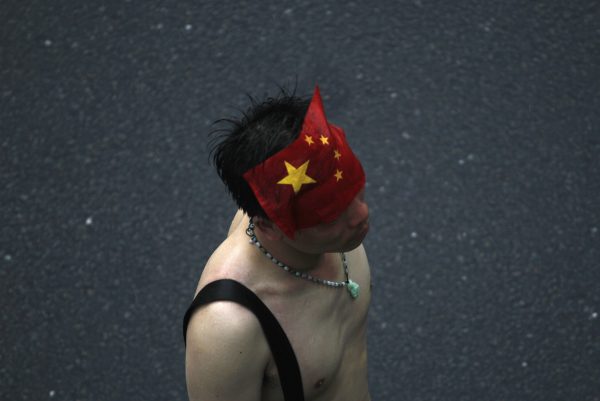 A protester, with an image of the Chinese national flag on his forehead, participates in an anti-Japan protest in Shenzhen, south China's Guangdong province, 19 August 2012. (Photo: Reuters/Tyrone Siu).