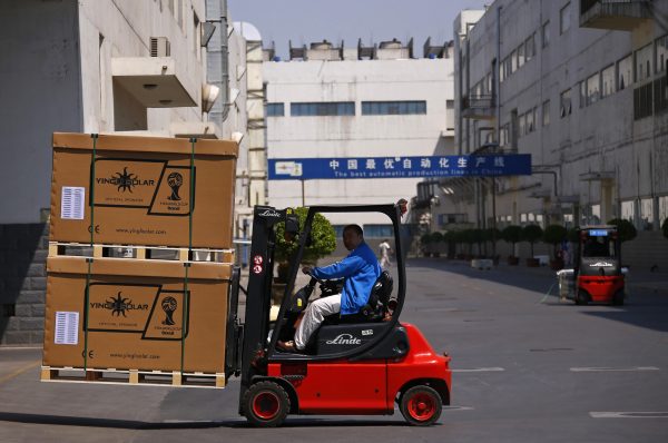 A man drives a forklift inside Yingli Solar in Baoding, Hebei province. Seven years ago, the Chinese city of Baoding launched an ambitious ‘low-carbon’ plan using renewables like solar power to light its streets and heat residential buildings, putting it at the forefront of China’s battle to cut pollution. (Photo: Reuters/ Petar Kujundzic).