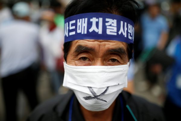 A Seoungju resident takes part in a protest against the government's decision on deploying a U.S. THAAD anti-missile defense unit in Seongju, in Seoul, South Korea, July 21, 2016. The head band reads 