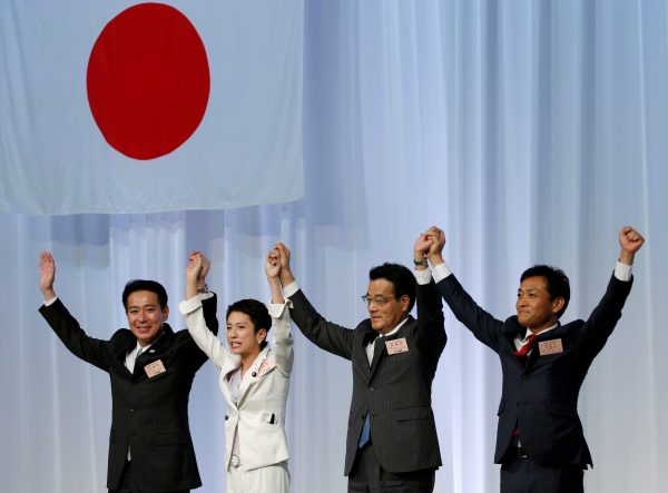 Japan's main opposition Democratic Party's new leader Renho raises her hands with Seiji Maehara and Katsuya Okada (Reuters/Toru Hanai).