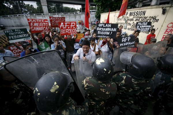 Youth activists hold up placards as they protest against the supposed killing of indigenous people in Mindanao by members of the military, Manila, 4 September, 2015. (Photo: Reuters/Al Falcon).