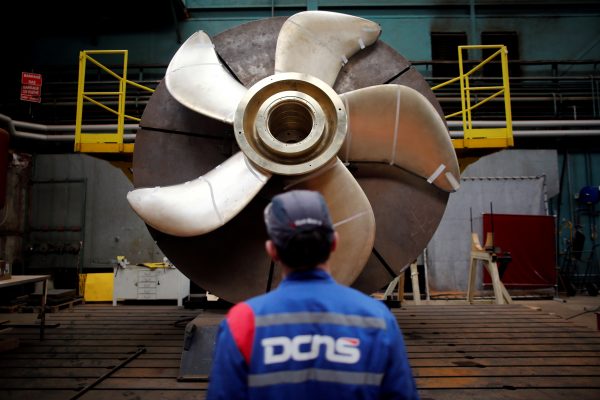 An employee looks at the propeller of a Scorpene submarine at the industrial site of the naval defence company and shipbuilder DCNS in La Montagne near Nantes, France, 26 April 2016. (Photo: Reuters/Stephane Mahe).