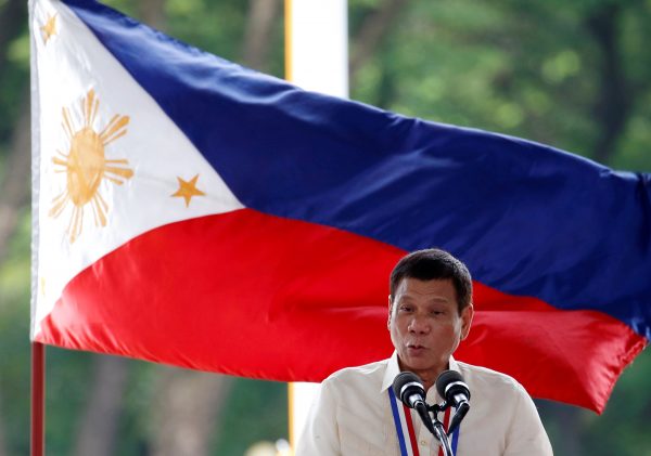 Philippine President Rodrigo Duterte speaks in front of a national flag during a National Heroes Day commemoration. (Photo: Reuters/Erik De Castro).