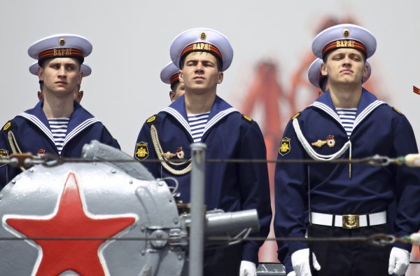 Russian sailors stand at attention on board a vessel during their departure to return to Russia at a port in Qingdao, Shandong province, China, 27 April 2012. (Photo: Reuters/China Daily).