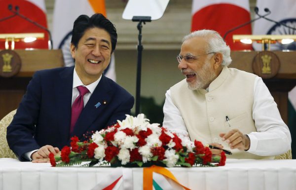 Japan's Prime Minister Shinzo Abe and his Indian counterpart Narendra Modi share a moment during a signing of an agreement at Hyderabad House in New Delhi, India, 12 December 2015 (Photo: Reuters/Adnan Abidi).