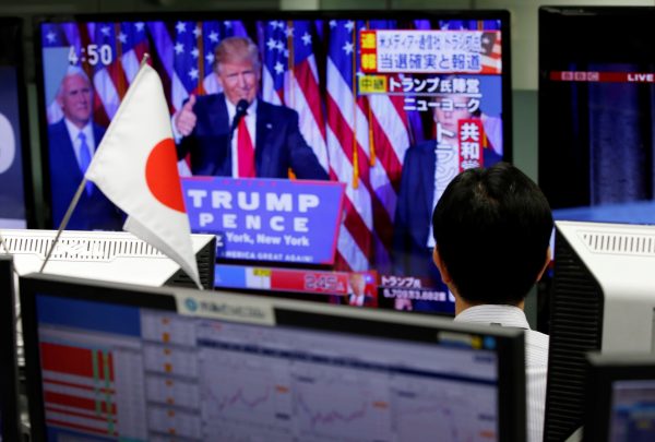 An employee of a foreign exchange trading company looks at a monitor showing US President-elect Donald Trump speaking on TV news in Tokyo, Japan, 9 November 2016. (Photo: Reuters/Toru Hanai).