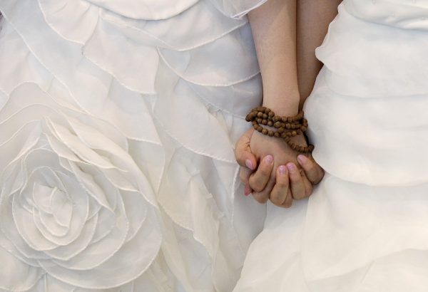 You Ya-ting and Huang Mei-yu hold hands after their symbolic same-sex Buddhist wedding ceremony at a temple in Taoyuan county, northern Taiwan, 11 August 11 2012, hoping that this wedding will help make Taiwan the first place in Asia to legalise same-sex marriage (Photo: Reuters/Pichi Chuang)
