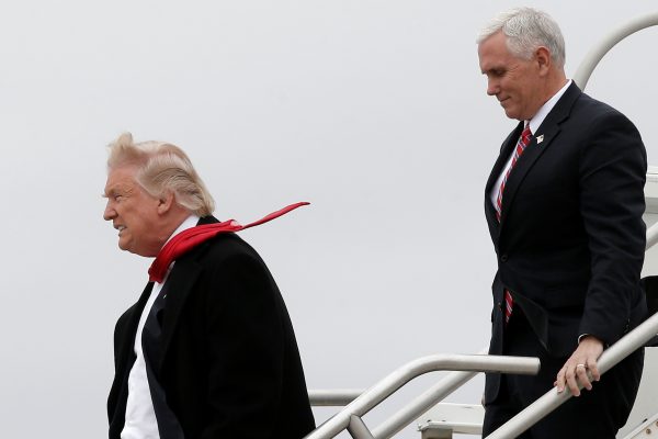 US President-elect Donald Trump and Vice-President elect Mike Pence walk off Trump's plane upon their arrival in Indianapolis, 1 December 2016. (Photo: Reuters: Mike Segar).