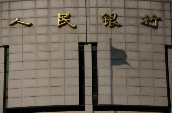 The shadow of a Chinese national flag is cast on the headquarters of the People's Bank of China — the country's central bank — in Beijing, China, 19 January 2016 (Photo: Reuters/Kim Kyung-Hoon).