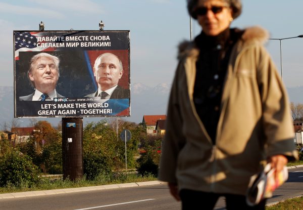 A woman passes a billboard showing a pictures of US president-elect Donald Trump and Russian President Vladimir Putin in Danilovgrad, Montenegro, 16 November 2016 (Photo: Reuters/Stevo Vasiljevic)