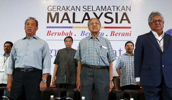 Malaysia's former deputy prime minister Muhyiddin Yassin, former prime minister Mahathir Mohamad and former minister Zaid Ibrahim stand for the national anthem during a meeting of political and civil leaders looking to change the government in Kuala Lumpur, Malaysia (Photo: Reuters/Olivia Harris).