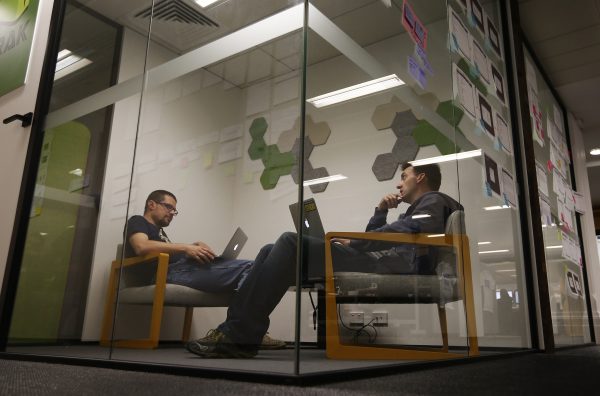Employees of software firm Atlassian are seen inside a meeting room at the company's office in central Sydney, 5 June 2013. (Photo: Reuters/Daniel Munoz).