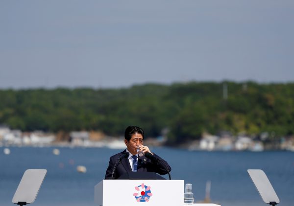 Japanese Prime Minister Shinzo Abe drinks water at a news conference during the G7 Ise-Shima Summit in Shima, Japan, 27 May 2016 (Photo: Reuters/Issei Kato).