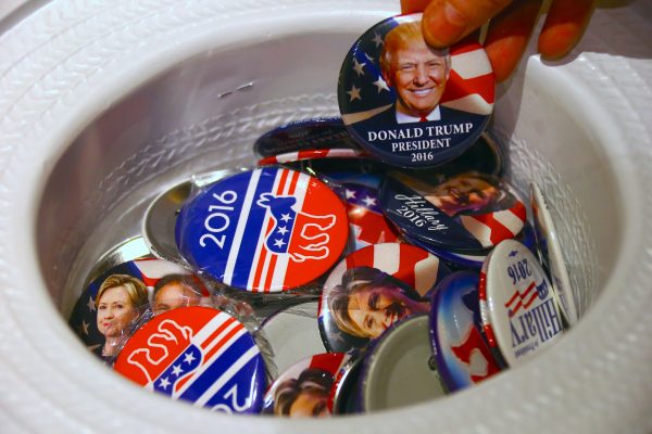 A badge from out of a hat displays photographs of Republican candidate Donald Trump and Democratic candidate Hillary Clinton (Photo: Reuters/David Gray).