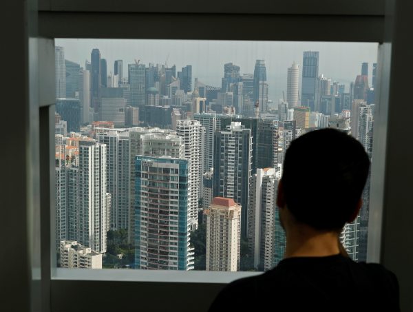 A man looks out at a cluster of private residential condominiums in Singapore, 10 February 2017 (Photo: Reuters/Edgar Su).