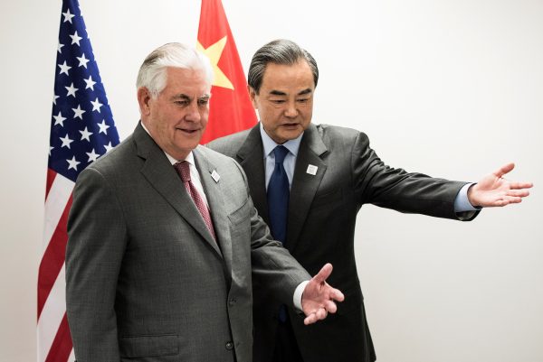 US Secretary of State Rex Tillerson (L) and China's Foreign Minister Wang Yi take their seats before a meeting on the sidelines of a gathering of Foreign Ministers of the G20 leading and developing economies at the World Conference Center in Bonn, western Germany, 17 February 2017. (Photo: Reuters/Brendan Smialowski).