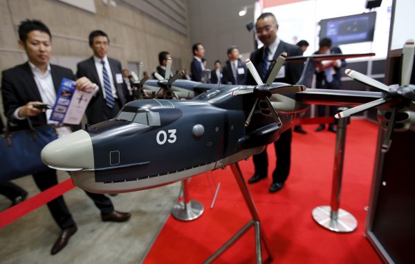 Visitors look at a model of a Japan Maritime Self-Defense Forces US-2 search-and-rescue amphibian plane during a defence exhibition and conference in Yokohama, Japan, 13 May 2015. (Photo: Reuters/Toru Hanai).