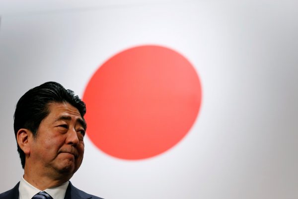 Japan's Prime Minister Shinzo Abe stands in front of the Japanese national flag after the Liberal Democratic Party's annual convention in Tokyo, 5 March 2017. (Photo: Reuters/Toru Hanai).