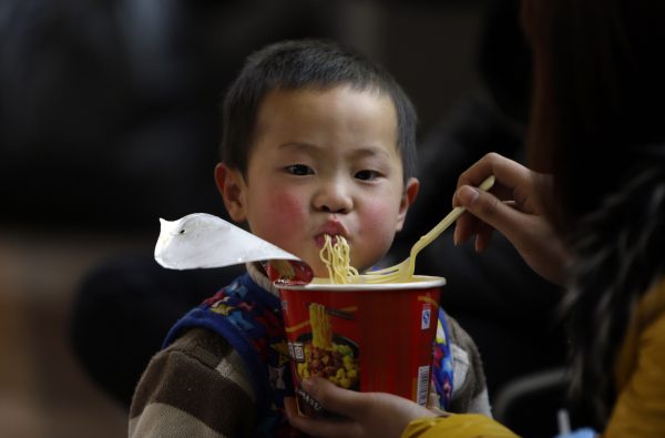 A child eating instant noodles at Zhengzhou Railway Station in Henan province, China. RCEP is designed to offer a wholesome trade menu by avoiding a proliferation of complex free trade agreements. (Photo: Reuters/Jason Lee).