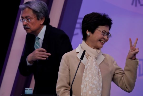 Hong Kong Chief Executive candidates former Financial Secretary John Tsang (L) and former Chief Secretary Carrie Lam (R) react at a debate in Hong Kong, China, 14 March 2017. (Photo: Reuters/Vincent Yu).