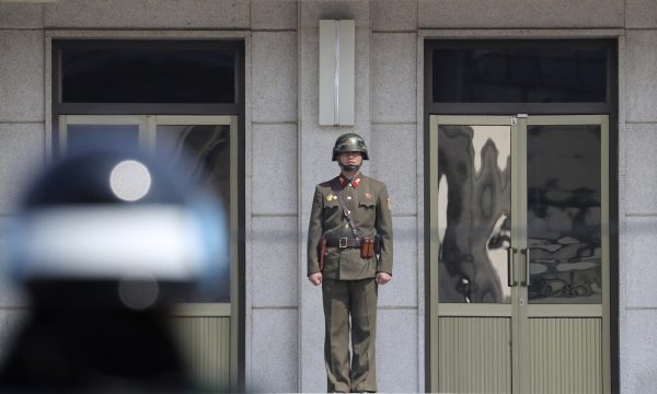 A North Korean soldier looks at the south side as a South Korean soldier stands guard before U.S. Secretary of State Rex Tillerson arrives at the border village of Panmunjom, which has separated the two Koreas since the Korean War, South Korea, 17 March 2017. (Photo: Reuters/Lee Jin-man).