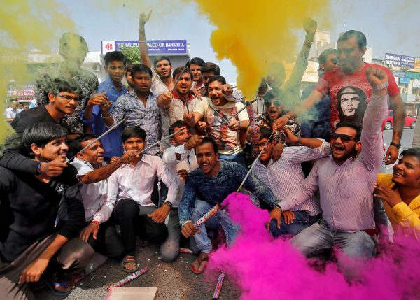 People light fire crackers and release coloured smoke during celebrations organised by Hindu nationalist group Vishva Hindu Parishad in the western city of Ahmedabad, India, 19 March 2017, after India’s ruling Bharatiya Janata Party leader Yogi Adityanath was sworn in as the new Chief Minister of the northern state of Uttar Pradesh on Sunday. (Photo: Reuters/Amit Dave).