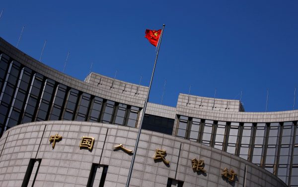 The national flag flies high above the headquarters of the central bank, the People’s Bank of China in Beijing. China still has the world’s largest foreign exchange reserves and the ability to implement strong capital controls (Photo: Reuters/Petar Kujundzic).