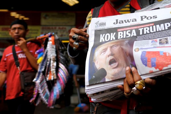 A newspaper seller holds a newspaper with an article about the election of US Republican candidate Donald Trump as president, in Jakarta, Indonesia, 10 November 2016. The headline reads 'Why Trump?' (Photo: Reuters)