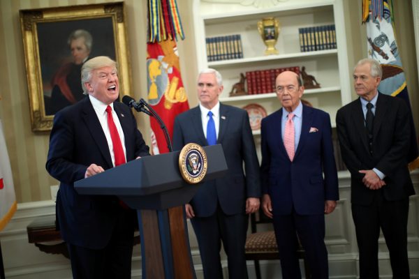 US President Donald Trump speaks during a signing ceremony of executive orders on trade, accompanied by Vice President Mike Pence and US Commerce Secretary Wilbur Ross at the Oval Office of the White House in Washington, US, 31 March 2017 (Photo: Reuters/Carlos Barria)