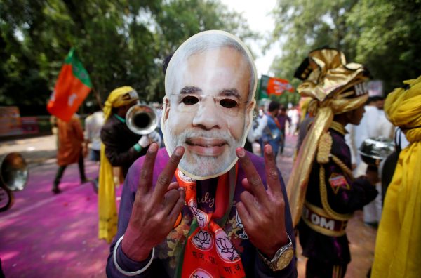 A supporter of India’s Bharatiya Janata Party (BJP) celebrates after learning of the initial poll results of the Uttar Pradesh state election outside the party headquarters in New Delhi, India, 11 March 2017. (Photo: Reuters/Adnan Abidi).
