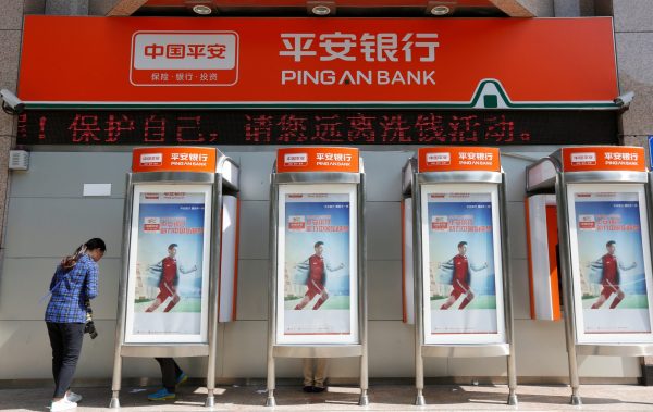 The name of Ping An Bank is displayed over its ATM booths outside a branch in Shenzhen, China 12 November 2016 (Photo: Reuters/Bobby Yip).