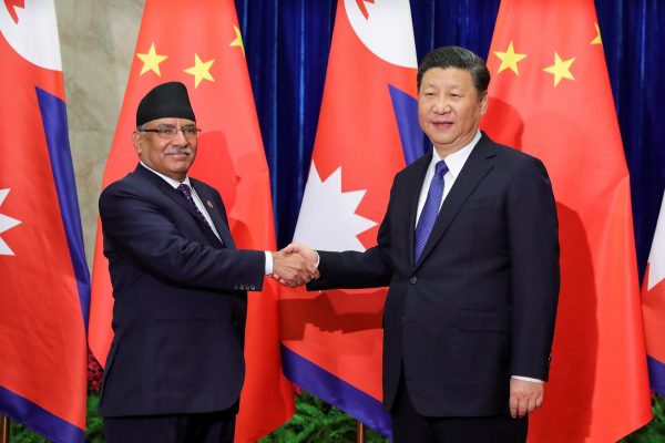 Chinese President Xi Jinping (R) shakes hands with Nepalese Prime Minister Pushpa Kamal Dahal (L) at the Great Hall of the People on March 27, 2017 in Beijing, China. (Photo: Reuters/Lintao Zhang).