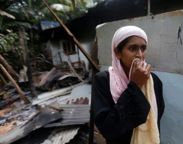 A Muslim woman stands next to her burnt house after a clash between Buddhists and Muslims in Aluthgama June 16, 2014. At least three Muslims were killed and 75 people seriously injured in violence between Buddhists and Muslims in southern Sri Lankan coastal towns best known as tourist draws, with Muslim homes set ablaze, officials and residents said on Monday. (Photo: Reuters/ Dinuka Liyanawatte)
