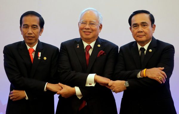 From left, Indonesian President Joko 'Jokowi' Widodo, Malaysian Prime Minister Najib Razak and Thai Prime Minister Prayuth Chan-ocha link arms as they pose for photographers during the 10th Indonesia-Malaysia-Thailand Growth Triangle (IMT-GT) Summit as part of the 30th Association of Southeast Asian Nations (ASEAN) summit in metropolitan Manila, Philippines, 29 April 2017. (Photo: Reuters/Aaron Favila).