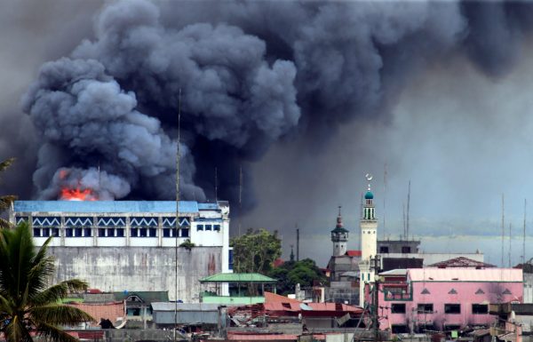 Black smoke comes from a burning building in a commercial area of Osmena street in Marawi city, Philippines June 14, 2017. (Photo: Reuters/Romeo Ranoco).