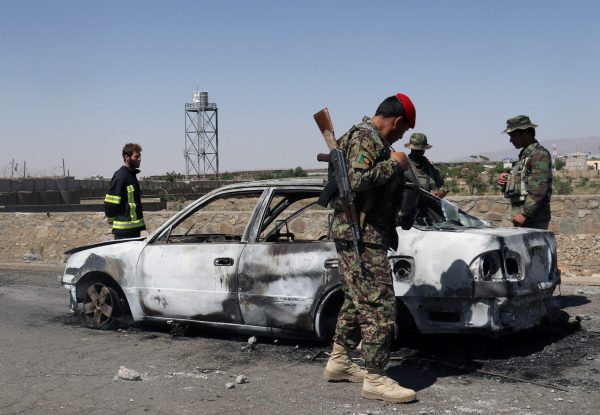 Afghan security forces inspect the exterior of a car after a suicide bomb blast in Gardez, Paktia Province, Afghanistan, 18 June 2017 (Photo: Reuters/Samiullah Peiwand).