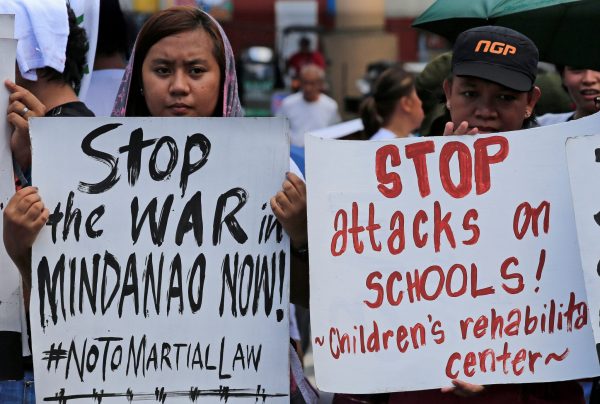 Activists hold placards calling for peace in war-torn Marawi as they join other protesters on President Rodrigo Duterte's first year in office during a rally outside the presidential palace in Metro Manila, Philippines 30 June 2017. (Photo: Reuters/Romeo Ranoco).