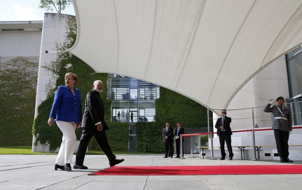 German Chancellor Angela Merkel walks with Indian Prime Minister Narendra Modi ahead of the 4th round of German-Indian government consultation at the Chancellery in Berlin, Germany, 30 May 2017 (Photo: Reuters/Fabrizio Bensch).
