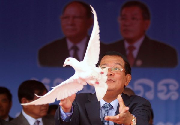 Cambodia's Prime Minister Hun Sen, who is also president of the ruling Cambodian People's Party, releases a dove during a ceremony at Koh Pich island to mark the 66th anniversary of the establishment of the party in Phnom Penh, Cambodia, 28 June 2017 (Photo: Reuters/Samrang Pring).