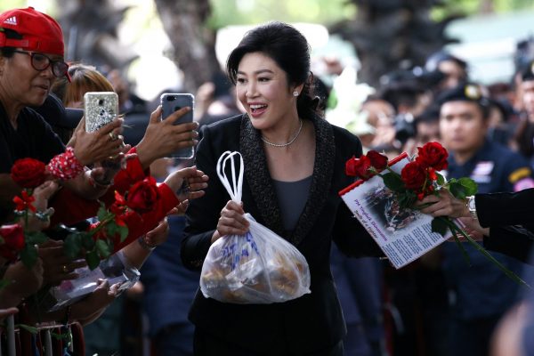 Ousted former Thai prime minister Yingluck Shinawatra greets supporters as she arrives at the Supreme Court in Bangkok, Thailand, 1 August 2017 (Photo: Reuters/Athit Perawongmetha).