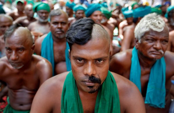 Farmers from the southern state of Tamil Nadu pose half shaved during a protest demanding a drought-relief package from the federal government, in New Delhi, India, 3 April 2017. (Photo: Reuters/Cathal McNaughton).
