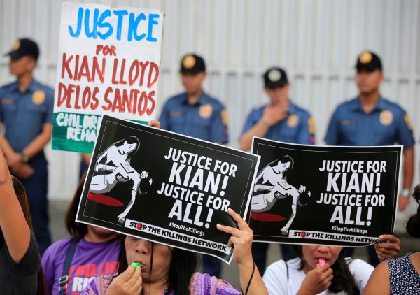 Protesters hold placards seeking justice for 17-year-old high school student Kian delos Santos, who was killed in a recent police raid in an escalation of President Rodrigo Duterte's war on drugs, during a protest in front of the Philippine National Police (PNP) headquarters in Quezon city, Metro Manila, Philippines 23 August 2017 (Photo: Reuters/Romeo Ranoco).