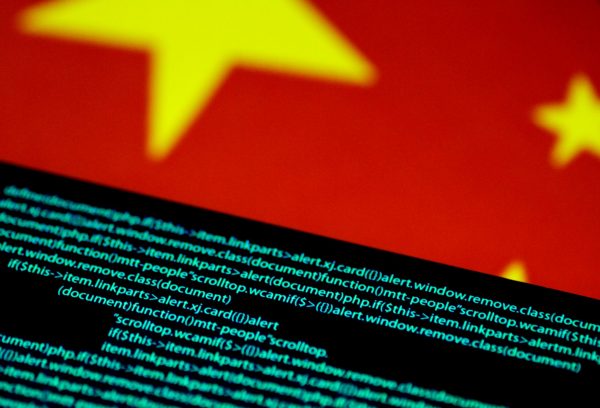 Computer code on a screen above a Chinese flag, 12 July, 2017 (Photo: Reuters/Thomas White).