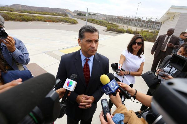 Attorney General of California Xavier Becerra speaks to the media at the US–Mexico border after announcing a lawsuit against the Trump Administration over its plans to begin construction of a border wall in San Diego and Imperial Counties, San Diego, California, 20 September, 2017 (Photo: Reuters/Mike Blake).