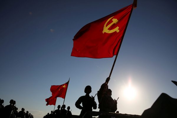Soldiers carry the Chinese Communist Party flag and Chinese national flag before the military parade to commemorate the 90th anniversary of the foundation of China's People's Liberation Army (PLA) at Zhurihe military base in Inner Mongolia Autonomous Region, China, 30 July, 2017 (Photo: Reuters/Stringer).