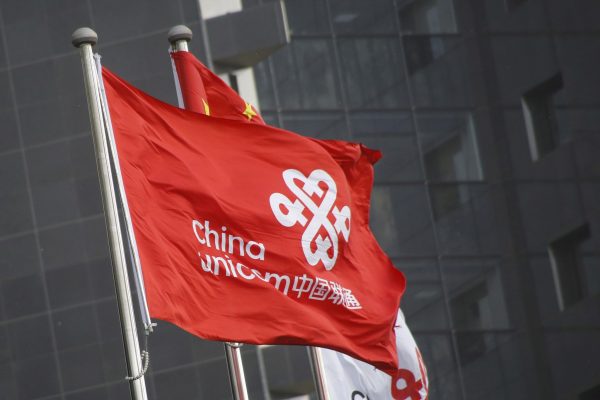 China Unicom's company flags flutter at its headquarter office in Beijing, China, 21 April 2016 (Photo: Reuters/Kim Kyung-Hoon).
