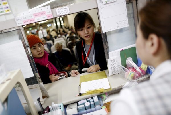 Dang Nguyen Thuc Vien, centre, the daughter of refugees from South Vietnam, interprets for a local Vietnamese resident at a hospital in Kanagawa prefecture, south of Tokyo. What constitutes an 'immigrant' in Japan 'has not been clearly defined'. (Photo: Reuters/Yuya Shino).
