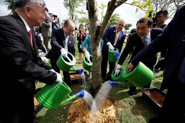 Delegates water a tree while they attend the inauguration of APEC Park in Danang, Vietnam, 9 November 2017. (Photo: Reuters/Kham).